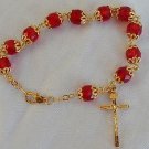 Red glass beads bracelet with golden cross