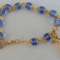 Light blue glass beads bracelet with golden cross