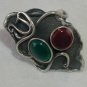 Black silver ring with red and green