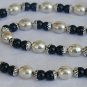 A silver necklace with onyx stones