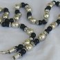 A silver necklace with onyx stones
