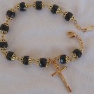 Black glass beads bracelet with golden cross