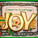 Christmas PIN #062 JOY Signed GCI Goldtone with Orn, Star & Bell w/Green Holly