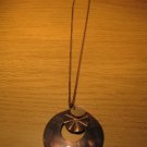 Brown shell medallion on brown chain