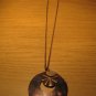 Brown shell medallion on brown chain