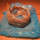 Intricately woven bead cuff in gold
