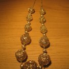 Gold tone wire 11 ball necklace