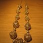 Gold tone wire 11 ball necklace