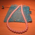 String of light pink faux pearls