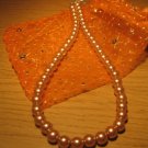 String of light brown faux pearls