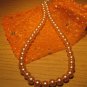 String of light brown faux pearls