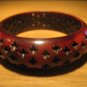 Brown resin bangle with 4-pointed star perforations