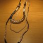 Black wood bead and silver tone metal bead tri-strand necklace