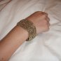 Intricately woven bead cuff in gold