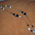 Black, white and gold glass, ceramic and metal bead necklace