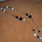 Black, white and gold glass, ceramic and metal bead necklace