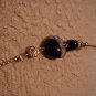 Black, white and gold glass, ceramic and metal bead necklace