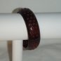 Brown resin bangle with 4-pointed star perforations