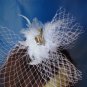 White feather fascinator with a diamond accent