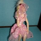Beautiful porcelin doll with pink dress and veil in sitting position 7"x5"X4"