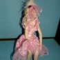 Beautiful porcelin doll with pink dress and veil in sitting position 7"x5"X4"