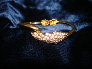 $9.99 Feather shape bracelet-adjustable size gold tone and crystal zirconia  bugget & round