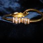 $9.99 Feather shape bracelet-adjustable size gold tone and crystal zirconia  bugget & round