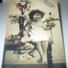 All Smiles with Little Girl Surrounded by Flowers-Used Antique 1907 Postcard