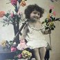 All Smiles with Little Girl Surrounded by Flowers-Used Antique 1907 Postcard