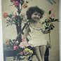 All Smiles with Little Girl Surrounded by Flowers-Used Antique 1907 Postcard