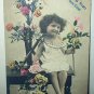 All Smiles with Little Girl Surrounded by Flowers-Used Antique 1907 Postcard