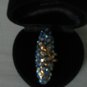 D008: Blue Swarovski Stone Ring with leaf engraving on gold base.