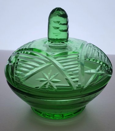 Green covered glass bowl with lid glows
