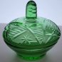 Green covered glass bowl with lid glows