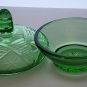 Green covered glass bowl with lid glows