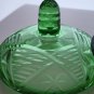 Green covered glass bowl with lid glows