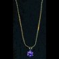Gold-tone pendant with amethyst-like stone