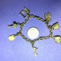 BRACELET 7 1/2" GOLD TONE 7 CHARMS BY DIAMONDS INTERNATIONAL #7002