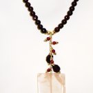 NK034       Rose Quartz Pendant in a Garnet Strand. Sterling Silver Beads and Clasps