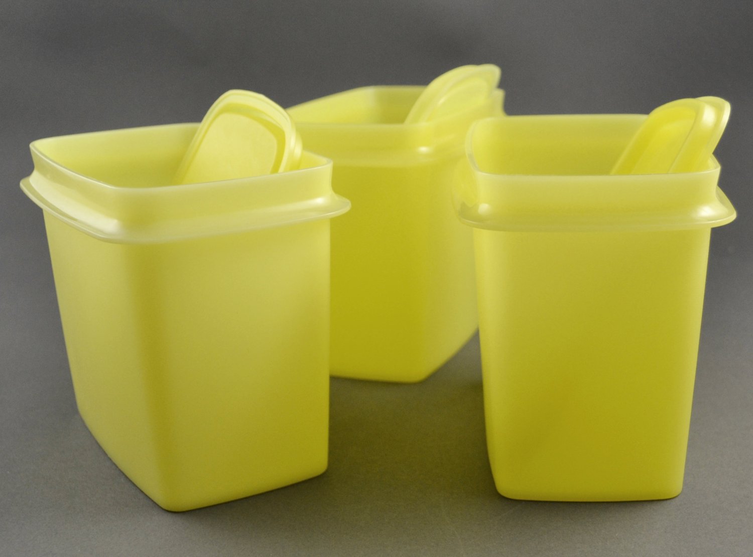 Check out these sunny yellow vintage Tupperware canisters! Two measuring  9.5” tall, and a third measuring 3.5” tall. Lids and canisters are…
